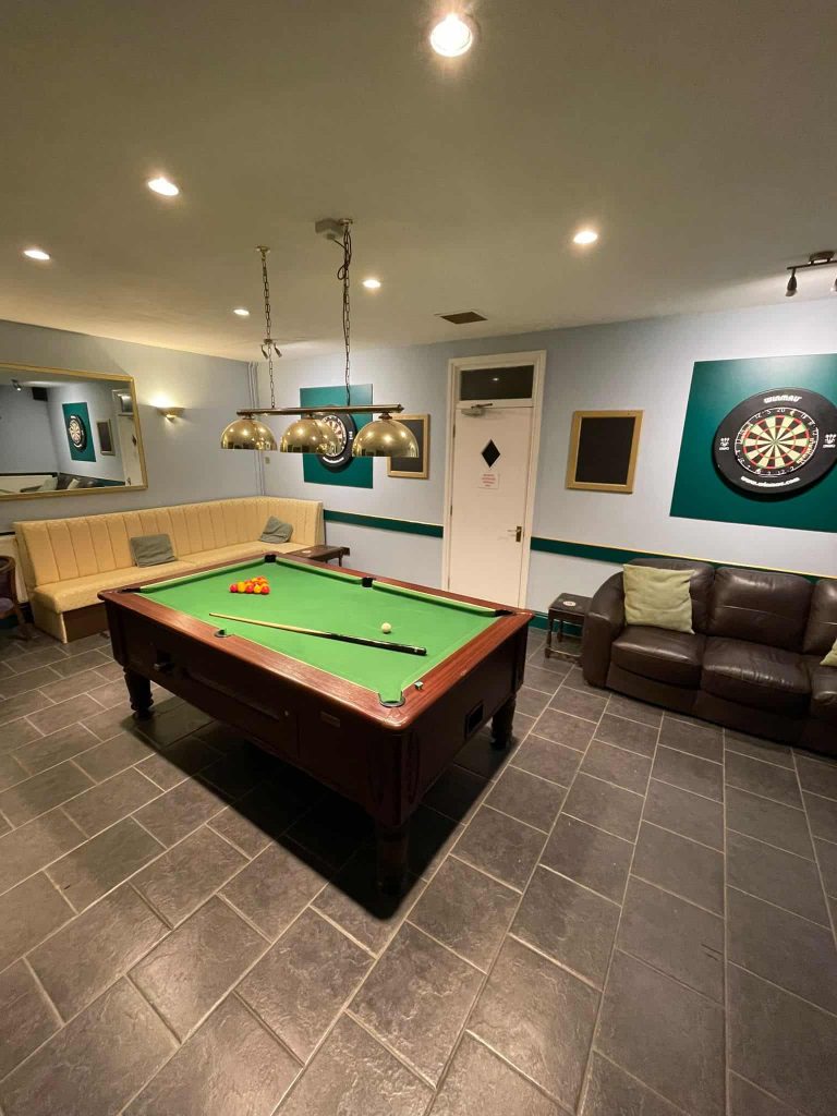pool room with two comfy sofas