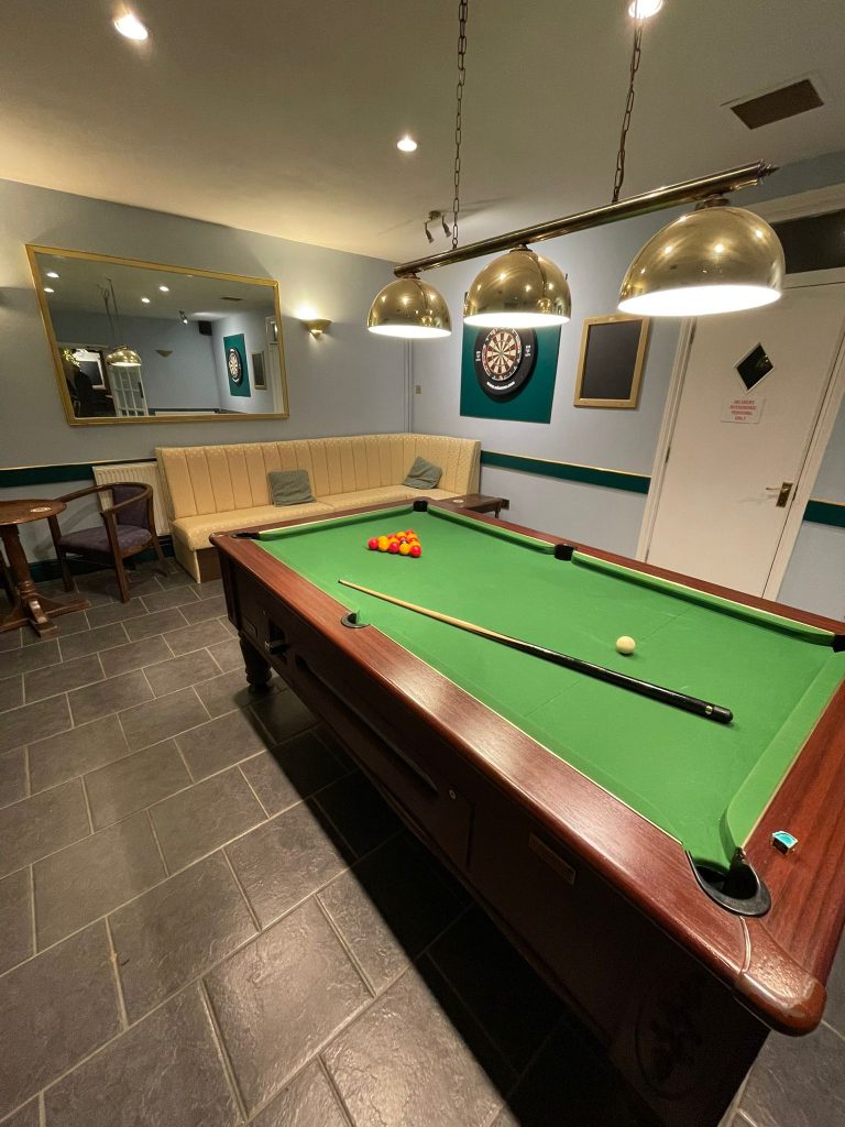 pool room withsofa, chair and table