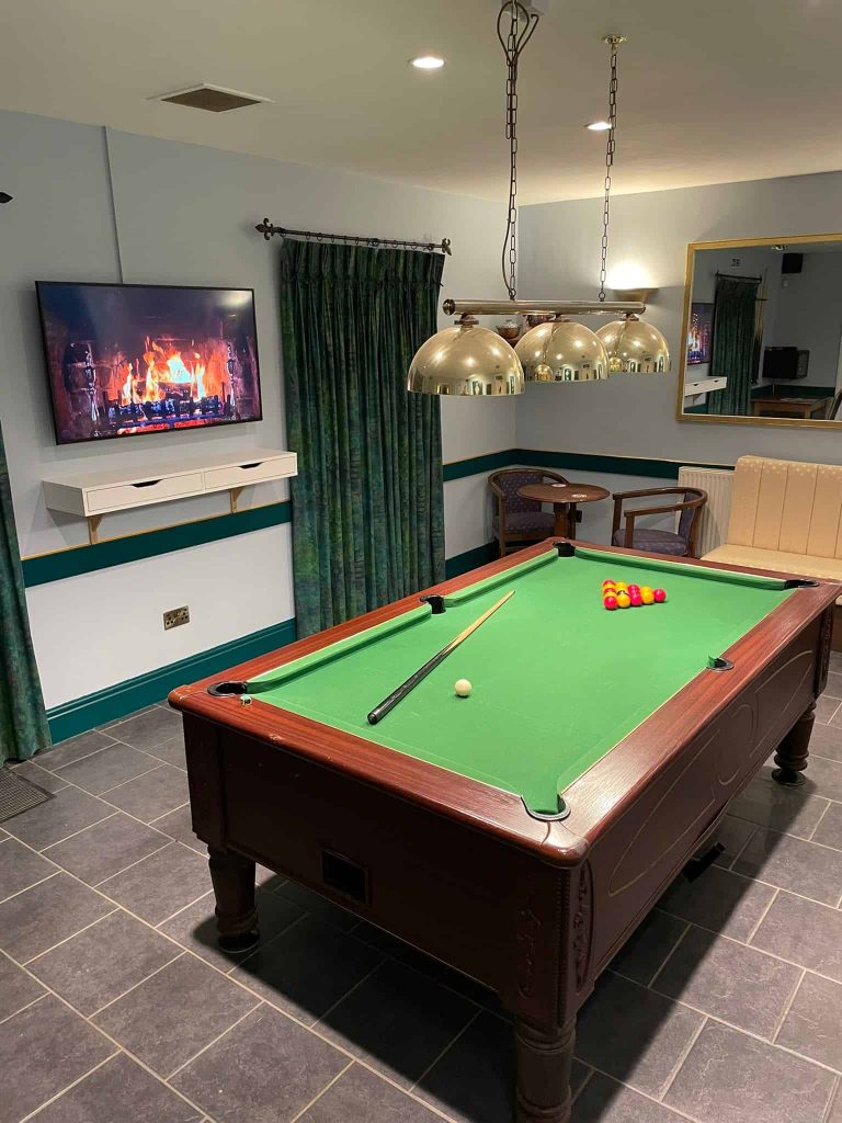 tv, table and chair with pool table